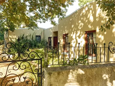 an iron gate in front of a building at The Neighbours Farm - Homestead in Stellenbosch