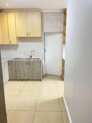 an empty kitchen with a sink and a door at The Perfect Place in Parow