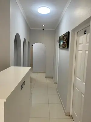 a hallway with a white door and a white tile floor at The Perfect Place in Parow