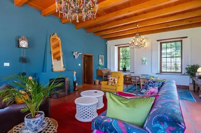 a living room with blue walls and a couch at The Manor at Mont Angelis Estate in Stellenbosch