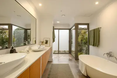 a bathroom with two sinks and a large mirror at Jonker Estate - Serene stay on Helshoogte Pass in Stellenbosch