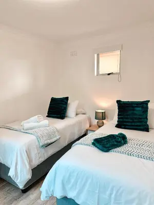 two beds sitting next to each other in a room at Ebb & Flow in Hermanus