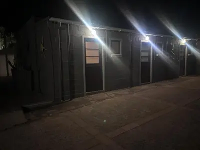 a couple of lights on a building at night at The Borris At Marnas Self Catering Accommodation in Joostenberg Vlakte
