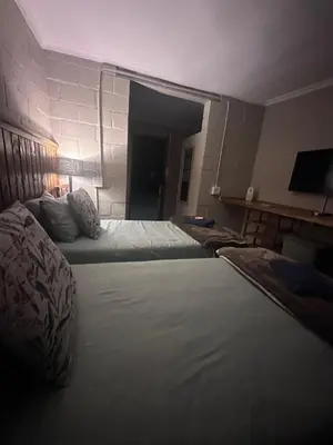 a hotel room with two beds and a hallway at The Borris At Marnas Self Catering Accommodation in Joostenberg Vlakte