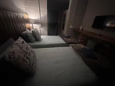 a bedroom with two beds and a table with a lamp at The Borris At Marnas Self Catering Accommodation in Joostenberg Vlakte