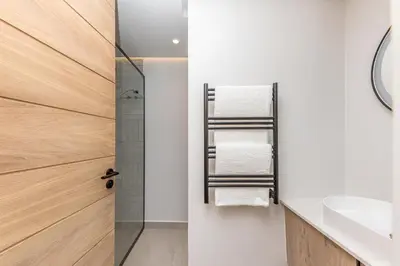a bathroom with a shower and a sink at Aan de Meul Luxury Apartments in Stellenbosch