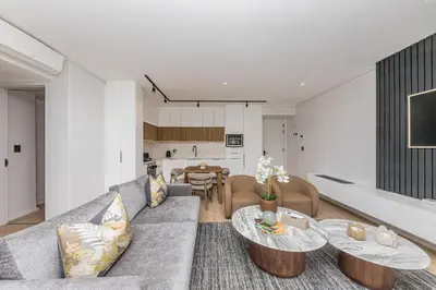 a living room with a couch and a table at Aan de Meul Luxury Apartments in Stellenbosch