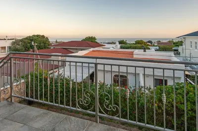 a balcony with a fence and flowers at Iets Nuuts in Hermanus