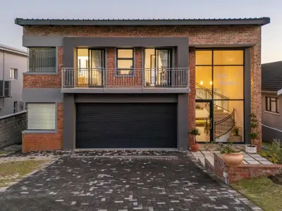 a brick house with a garage at Iets Nuuts in Hermanus
