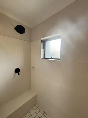 a bathroom with a shower with a window at Seabreeze Summit Retreat Your Perfect Escape in Cape Town