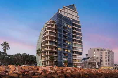 a tall building next to a pile of rocks at 903 Atlantica in Strand
