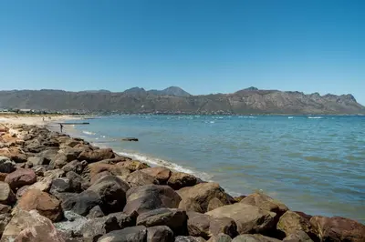 a group of rocks on a beach near the water at 903 Atlantica in Strand