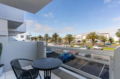 a balcony with a table and a view of a parking lot at South Views 14 in Cape Town
