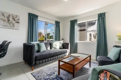 a living room with a couch and a table at Manhattan Square 17 in Cape Town