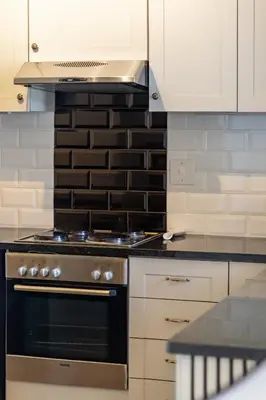a kitchen with a stove top oven in a kitchen at 2 Bedroom, Mountain View Penthouse, Century City in Cape Town