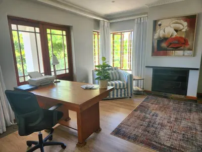 a living room with a desk and a chair at Sea 'n Summit Hermanus in Hermanus
