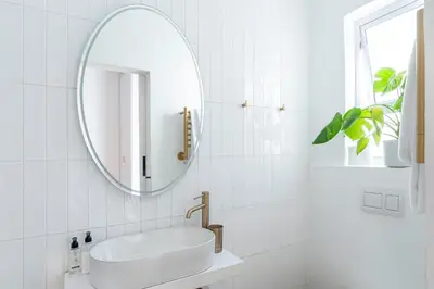 a white bathroom with a sink and a mirror at 107 Dorpstraat Boutique Hotel in Stellenbosch