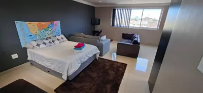 a small room with a bed and a couch at Murray Guest Suite in Goodwood