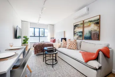 a living room with a couch and a bed at 136 Paarl Studio With Onsite Parking Comforts in Paarl