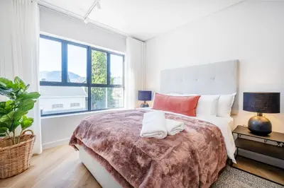 a bedroom with a large bed and a large window at 136 Paarl Studio With Onsite Parking Comforts in Paarl