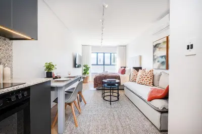 a kitchen and living room with a couch and a table at 136 Paarl Studio With Onsite Parking Comforts in Paarl
