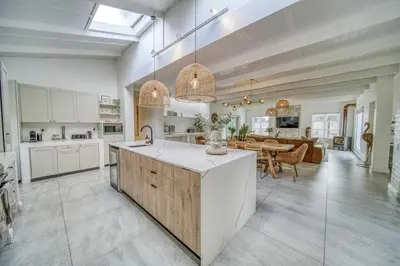 a kitchen and living room with a table in it at Luxury Flamingo Villa at beach with Pool and Solar Back Up in Cape Town