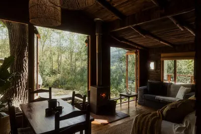 a living room with a fireplace in a house at Glen Oakes Farm Stay in Hartebeest Rivier