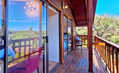 a porch with a view of the mountains at Beach House, Pool, Braai, Patio, Water Sports in Hermanus