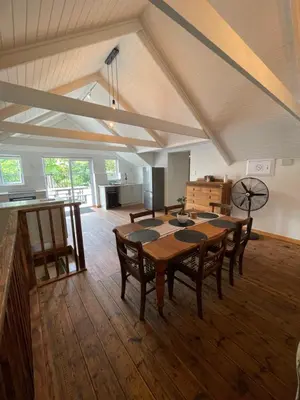 a large room with a wooden table and chairs at Stay At Nantes in Paarl