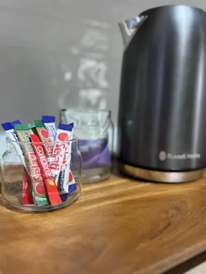 a jar of toothpaste and chips on a counter next to a blender at Inside Out Bliss in Paarl