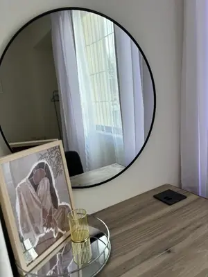 a mirror sitting on top of a table with a picture at Inside Out Bliss in Paarl