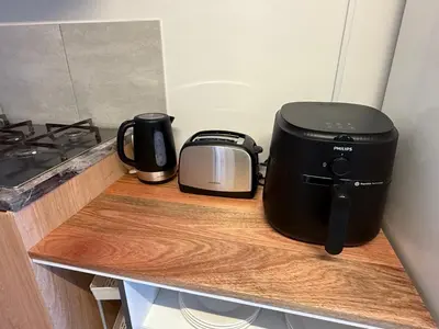 a toaster and coffee pot sitting on a counter at Secure & Central, Modern Flatlet in Cape Town