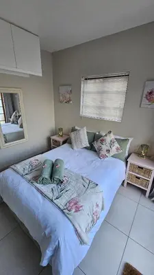a bedroom with a large bed with pillows on it at Protea Rus in Wellington
