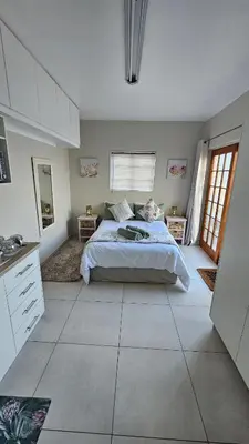 a large bedroom with a bed and a window at Protea Rus in Wellington
