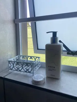 a bottle of first flush sitting next to a window at The Perfect Spot in Welgelegen