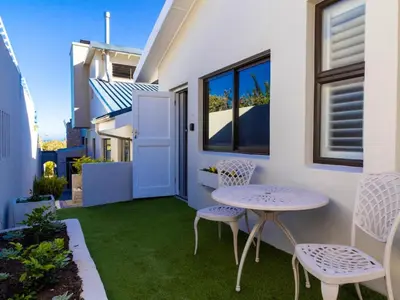 a small patio with a table and two chairs at Mountain Rest Hermanus in Hermanus