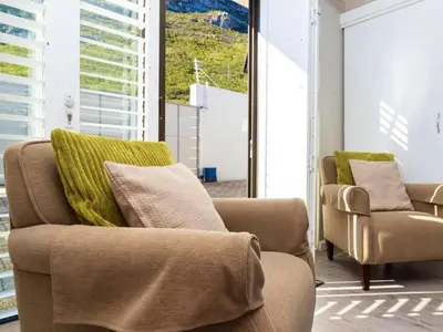 a living room with two chairs and a couch at Mountain Rest Hermanus in Hermanus