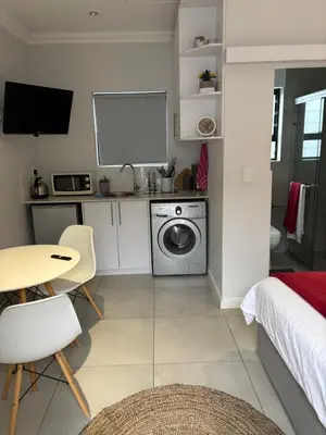 a kitchen with a washer and dryer in a room at Studio Apartment in Cape Town in Cape Town