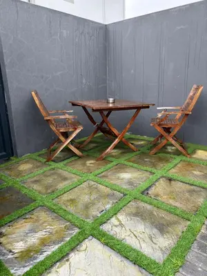 two chairs and a wooden table and two chairs at Studio Apartment in Cape Town in Cape Town