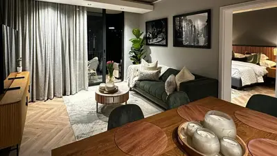 a living room with a couch and a dining room table at ON PARK 317 LUXURY APARTMENT CENTURY CiTY in Century City