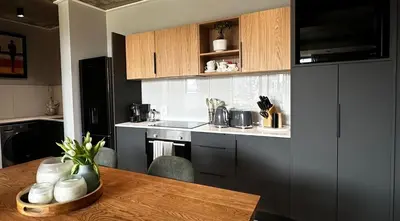 a kitchen with a wooden table and a counter top at ON PARK 317 LUXURY APARTMENT CENTURY CiTY in Century City