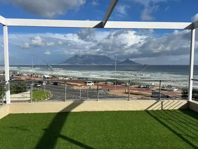 a view of the ocean and a parking lot at Luxury Portico Apartment in Cape Town