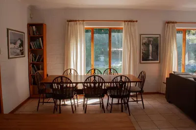 a dining room with a table and chairs at Yellowwood Place in Bettyʼs Bay
