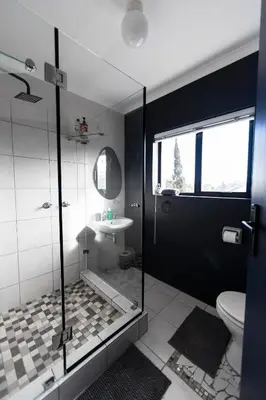 a bathroom with a shower and a toilet and a sink at Apartment Paradys 2 - Serviced in Stellenbosch