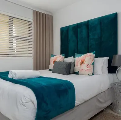 a bedroom with two beds with blue and white at JC Mountain View in Cape Town