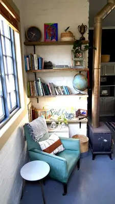 a living room with a couch and a table at The Art Room in Somerset West