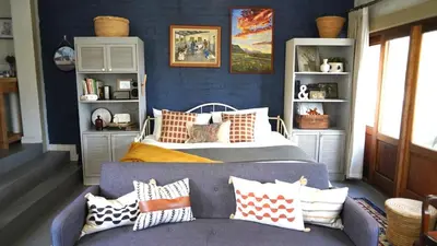 a bedroom with a bed and a couch at The Art Room in Somerset West