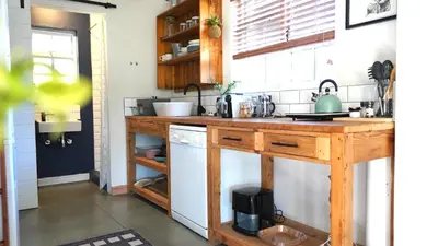 a kitchen with a wooden counter top in a room at The Art Room in Somerset West