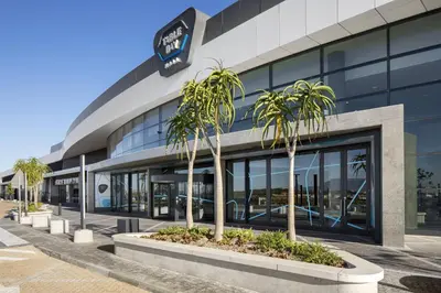 a building with palm trees in front of it at 21b on SANDOWN in Cape Town
