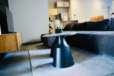 a living room with a table and a couch at 21b on SANDOWN in Cape Town